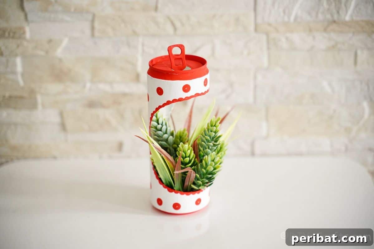 succulent planter made of a coke can on white table