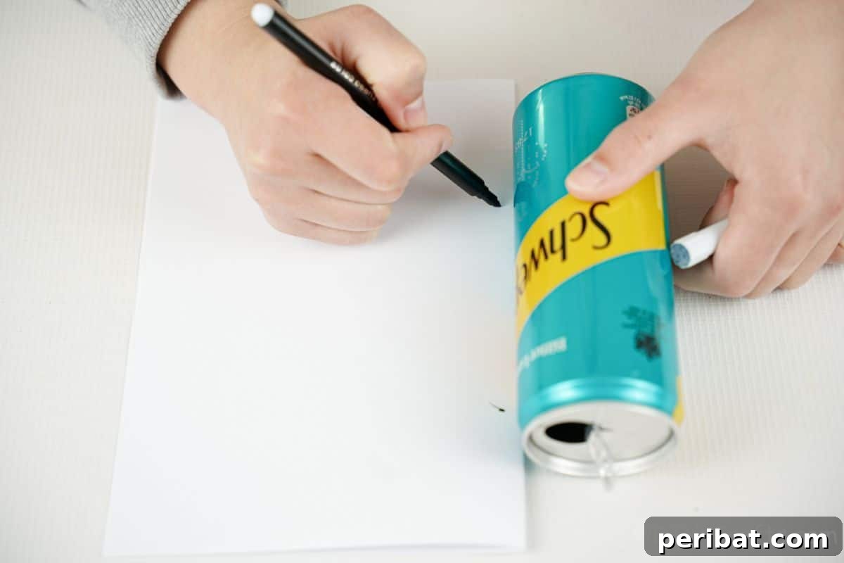 hand tracing shape on white paper next to blue and yellow soda can