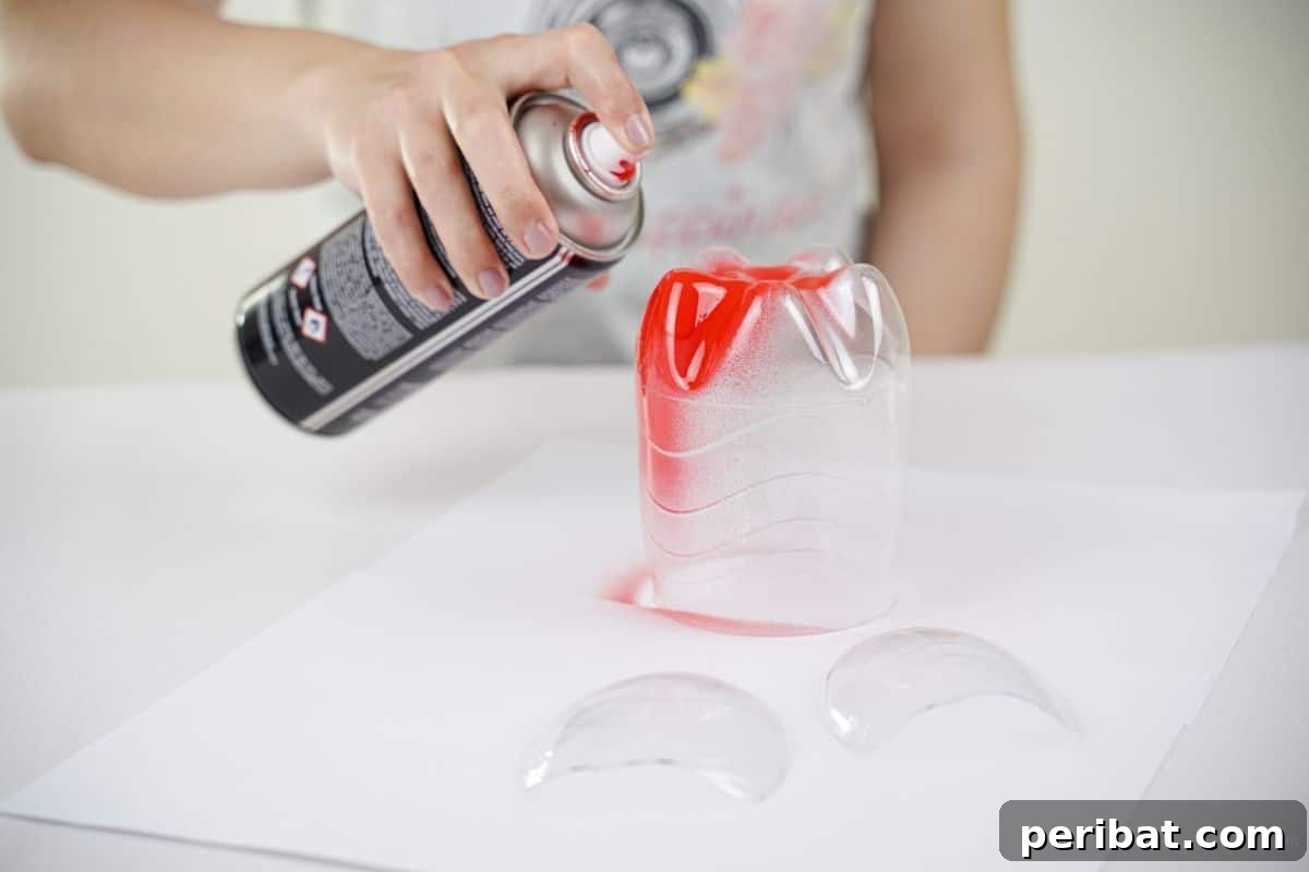 Upcycled Ladybug Garden Gems 13 hand spraying plastic bottle pieces with red spray paint