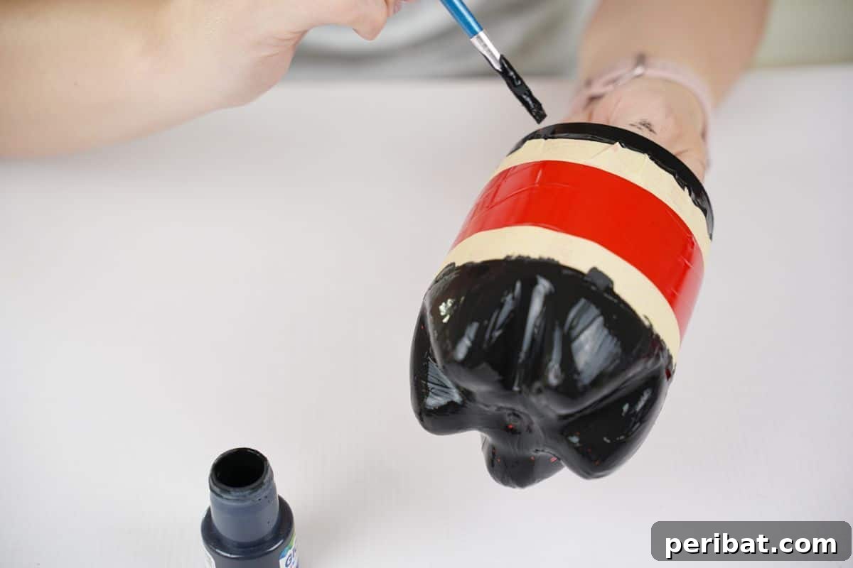 Upcycled Ladybug Garden Gems 16 hand painting black paint above tape line on bottle