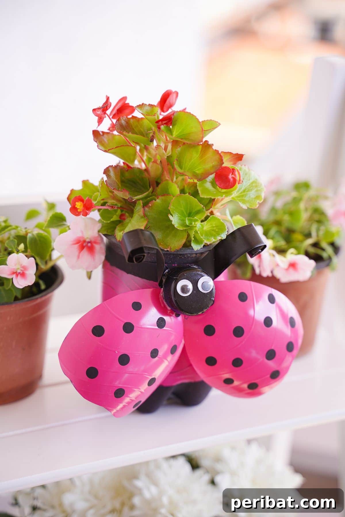 Upcycled Ladybug Garden Gems 23 pink and black ladybug planter on white stool