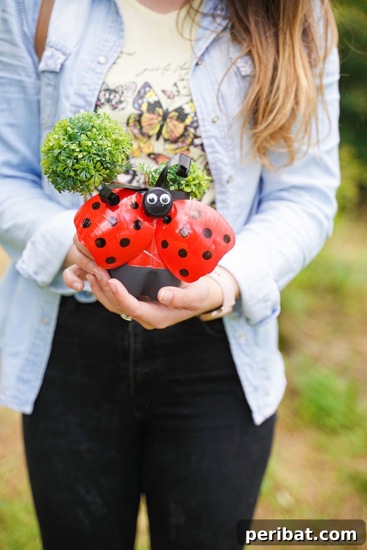 Upcycled Ladybug Garden Gems 24 red ladybug planter held by woman