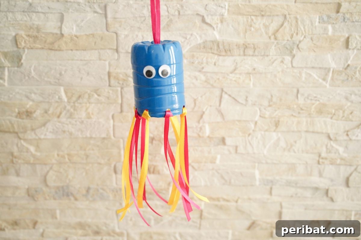 Vibrant Upcycled Bottle Wind Streamer 15 Plastic bottle windsock against a cream brick wall, ready for display