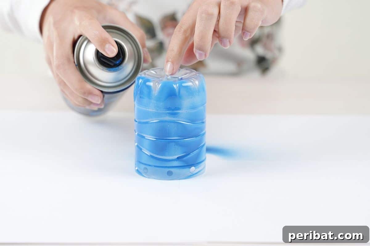 Vibrant Upcycled Bottle Wind Streamer 10 Plastic bottle being sprayed with blue paint