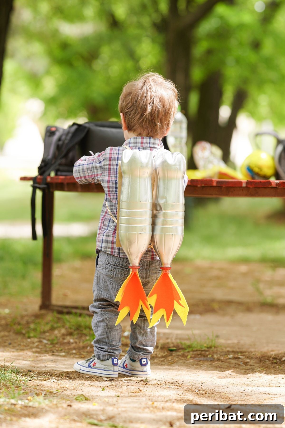 Bottle Blaster Backpack 9 little boy wearing jet pack in front of park bench