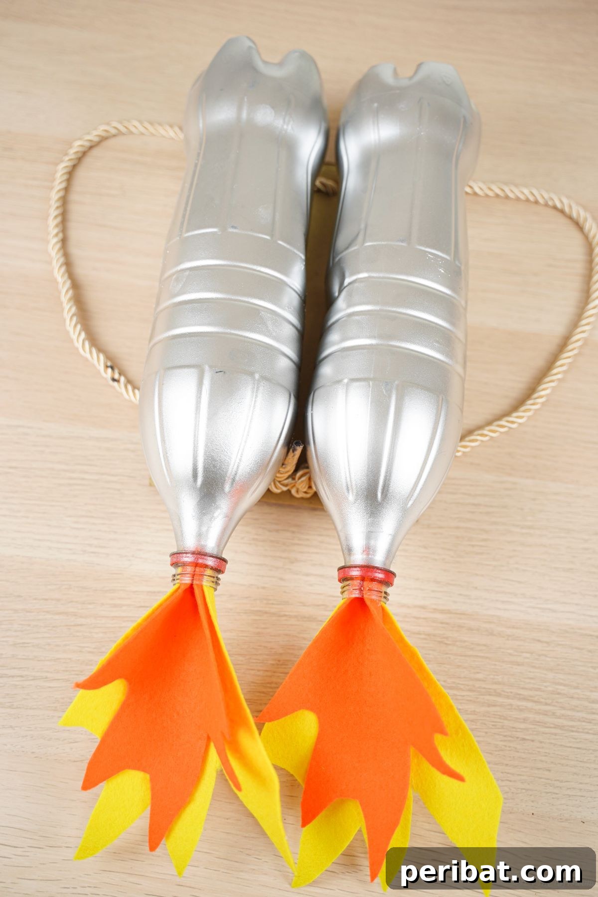 Bottle Blaster Backpack 3 silver painted bottle fake jetpack on wood table
