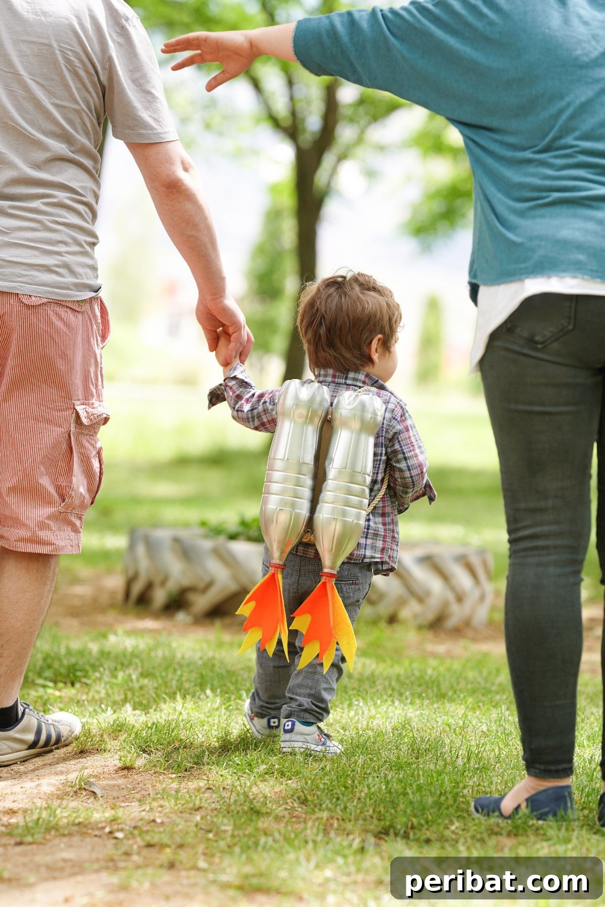 Bottle Blaster Backpack 4 little boy wearing jet pack holding parents hand