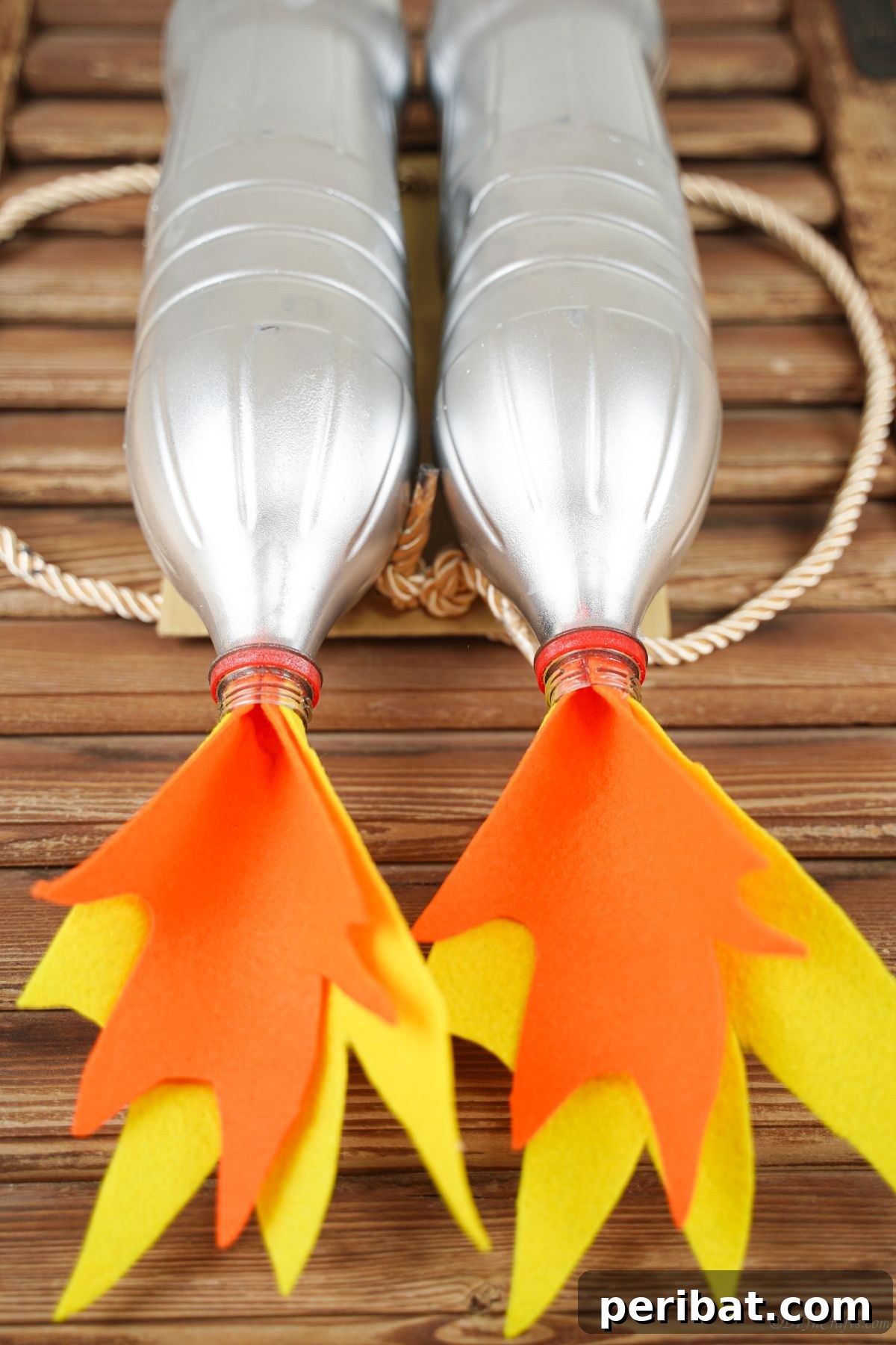 Bottle Blaster Backpack 12 orange and yellow felt flames at the bottom of silver jet pack