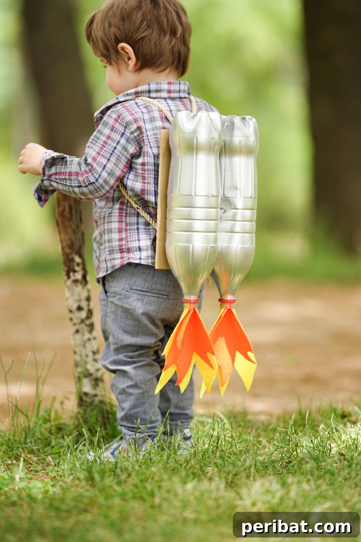 Bottle Blaster Backpack 6 toddler holding stick while wearing silver jet pack costume