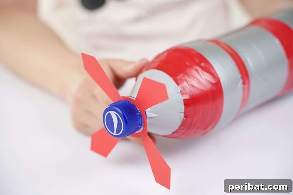 The bottle lid screwed over the end of the bottle, firmly securing the red propeller in place.