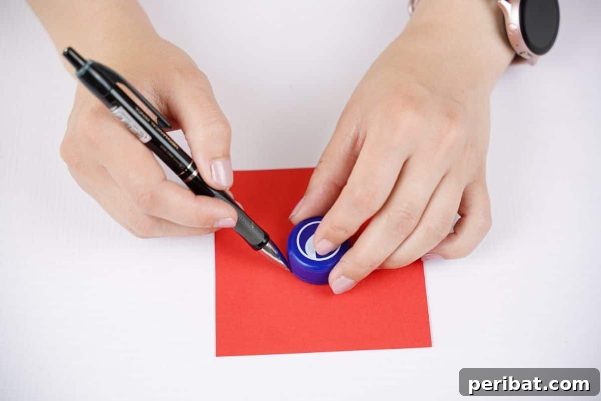 A pen tracing around the bottle lid on red paper to sketch the outlines of the propeller blades.