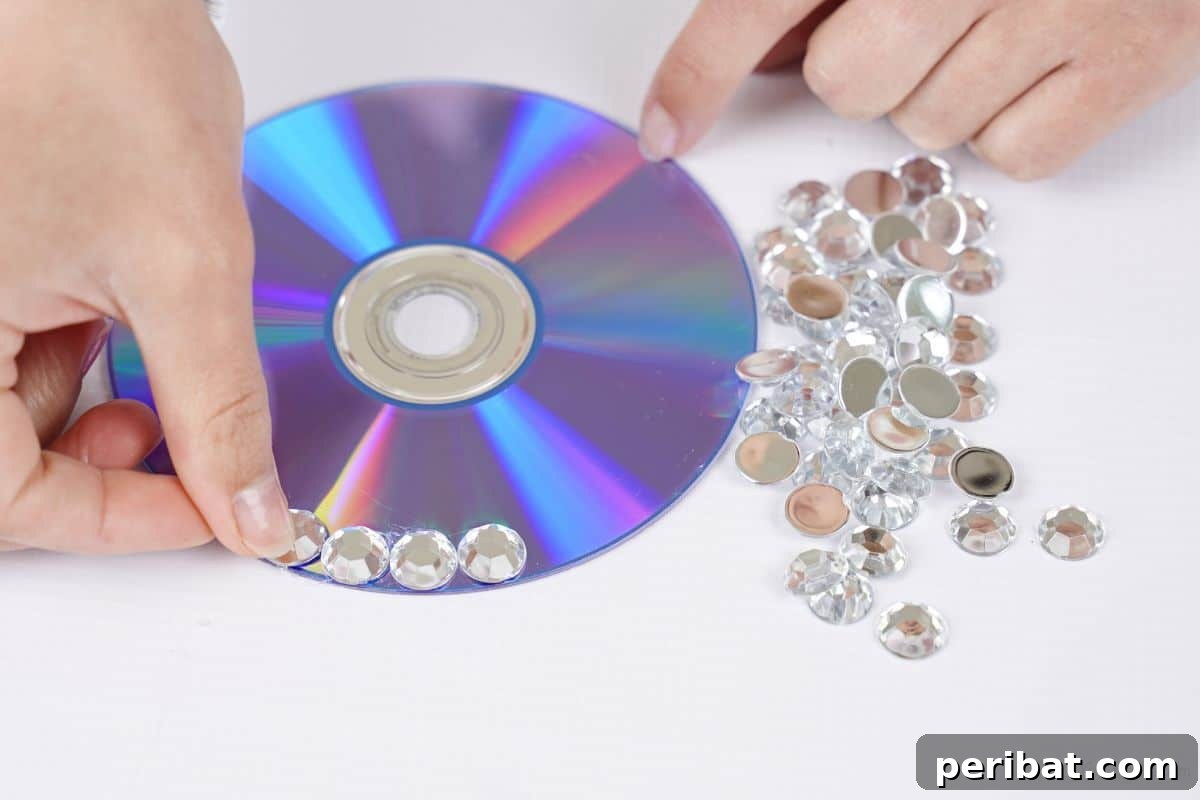 Radiant Recycled Rhinestone Vase 11 rhinestones being glued onto a CD