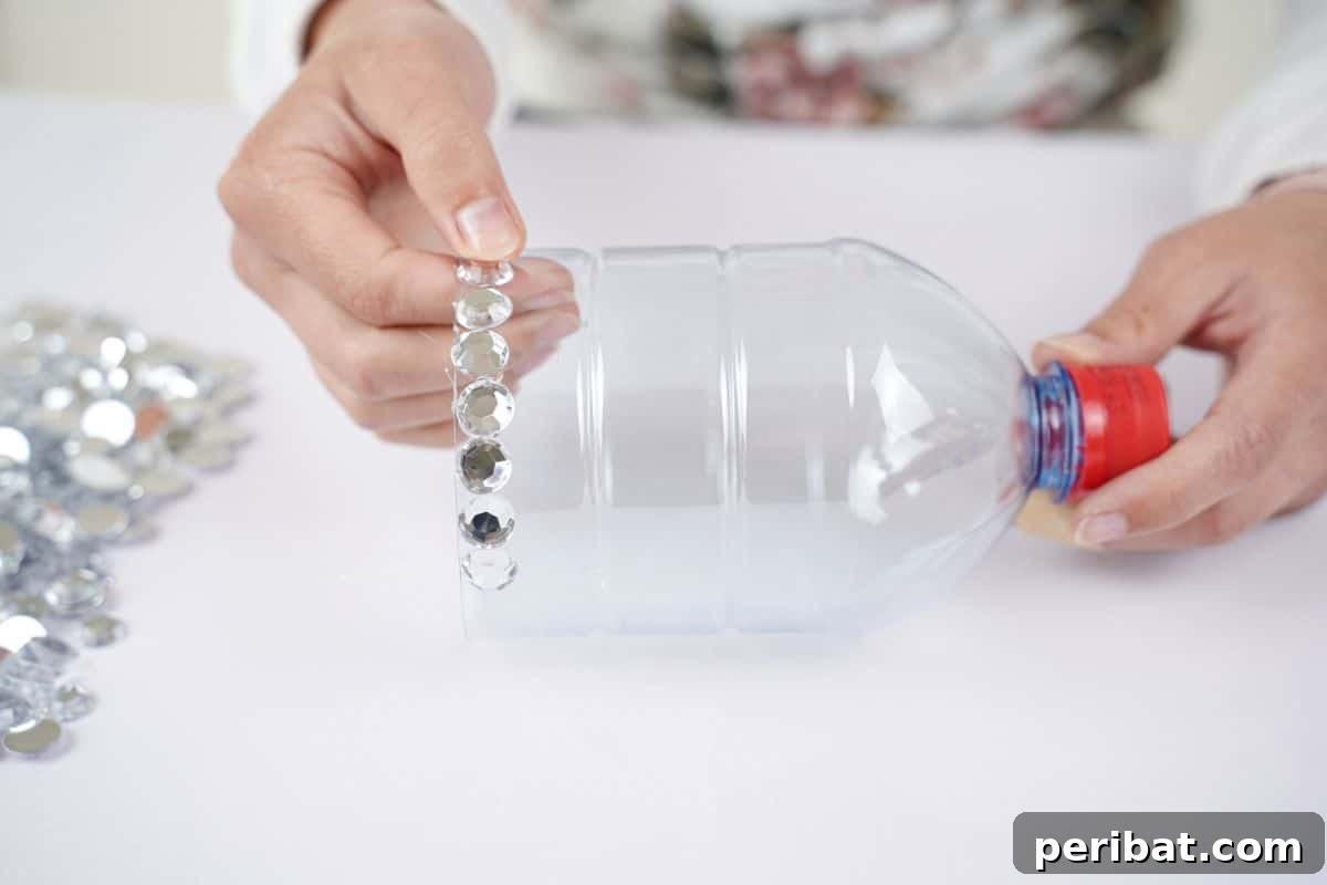 Radiant Recycled Rhinestone Vase 16 hand holding rhinestones on bottle