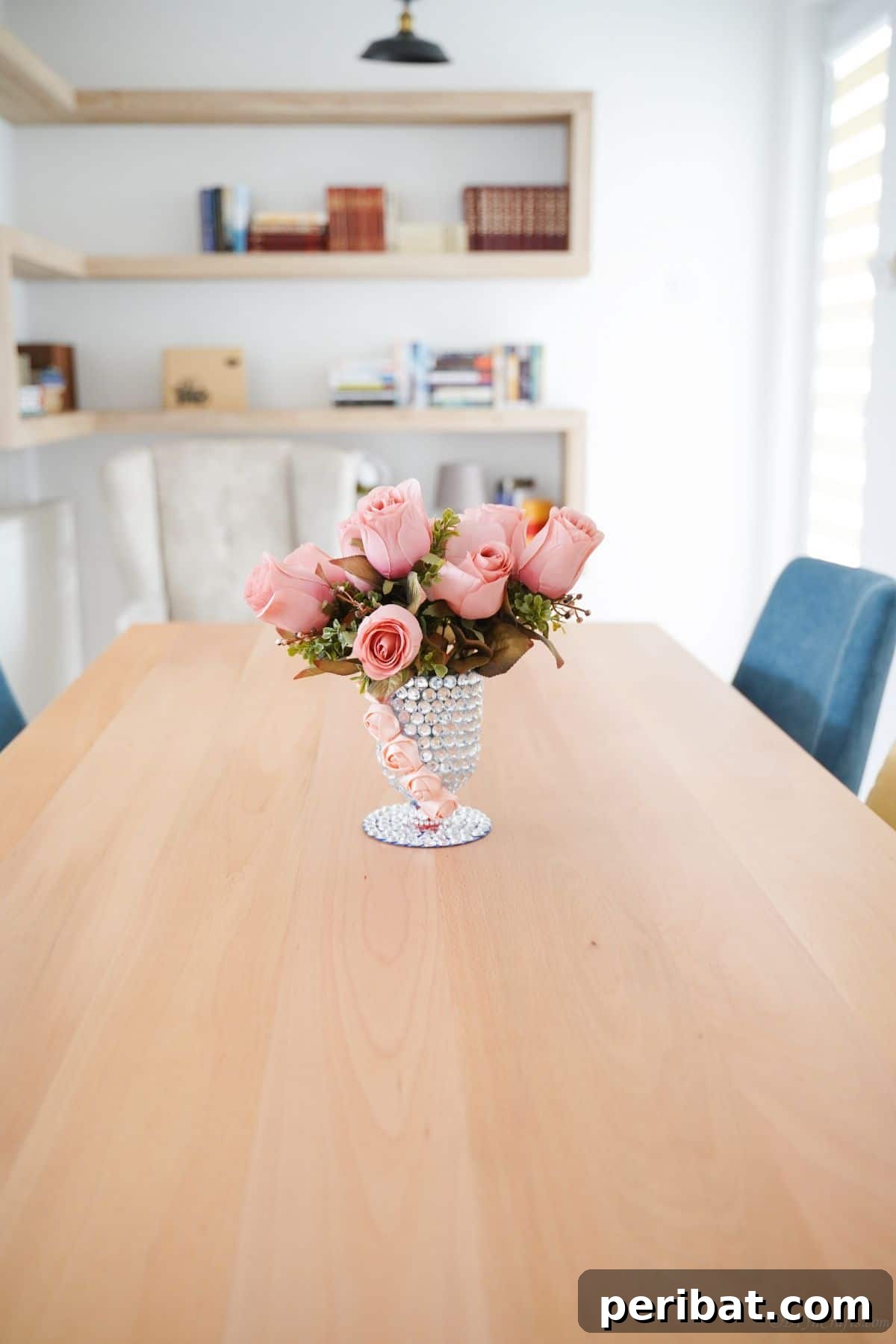 Radiant Recycled Rhinestone Vase 5 dining table with blue chairs and rhinestone vase of roses in center