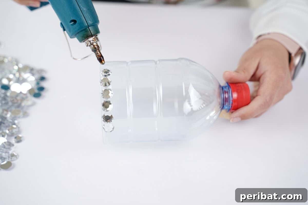 Radiant Recycled Rhinestone Vase 9 blue glue gun attaching rhinestones to bottle