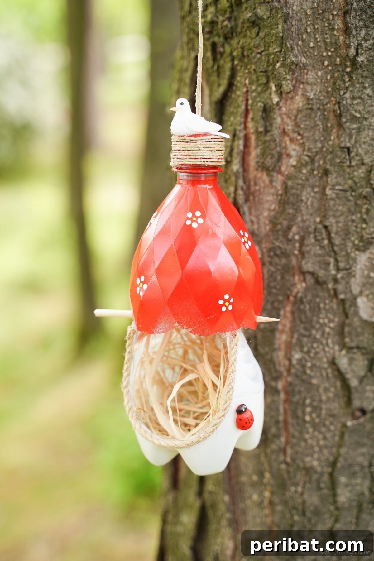 Upcycled Bottle Birdhouse 20 Upcycled plastic bottle bird nest securely attached to a tree trunk, showcasing its unique design