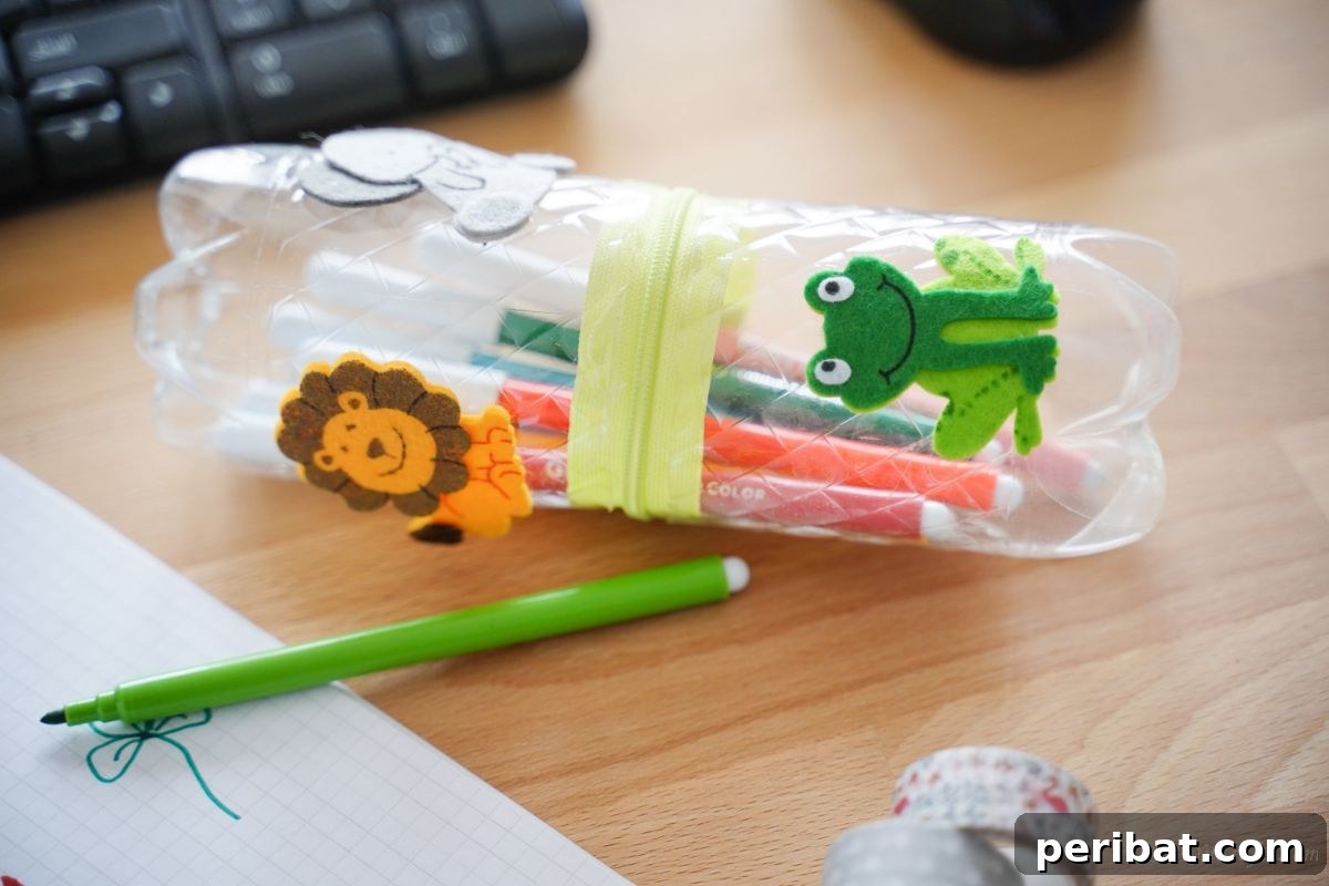 Stitch-Free Upcycled Bottle Stationery Pouch 13 Plastic bottle pencil holder adorned with charming frog and lion stickers, showcasing playful decoration ideas.