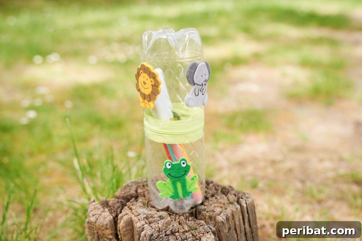 Stitch-Free Upcycled Bottle Stationery Pouch 3 Colorful animal print upcycled pencil holder resting on a tree stump outdoors, highlighting outdoor-friendly storage.