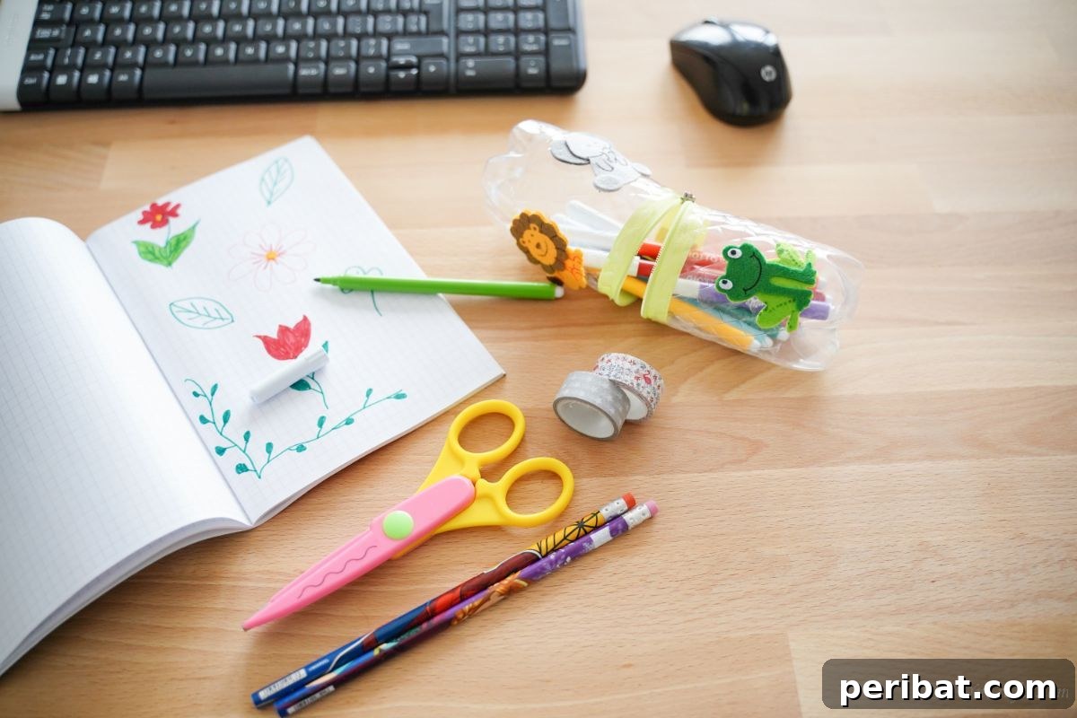 Stitch-Free Upcycled Bottle Stationery Pouch 5 Stylish plastic bottle pencil case on a desk, surrounded by scissors, pencils, and a keyboard, ready for use.
