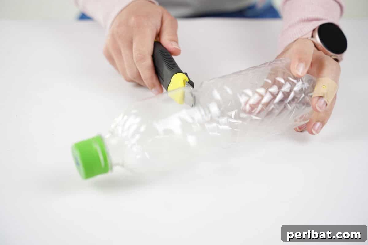 Stitch-Free Upcycled Bottle Stationery Pouch 9 Craft knife meticulously cutting a plastic bottle in half, illustrating the precision required for the DIY project.