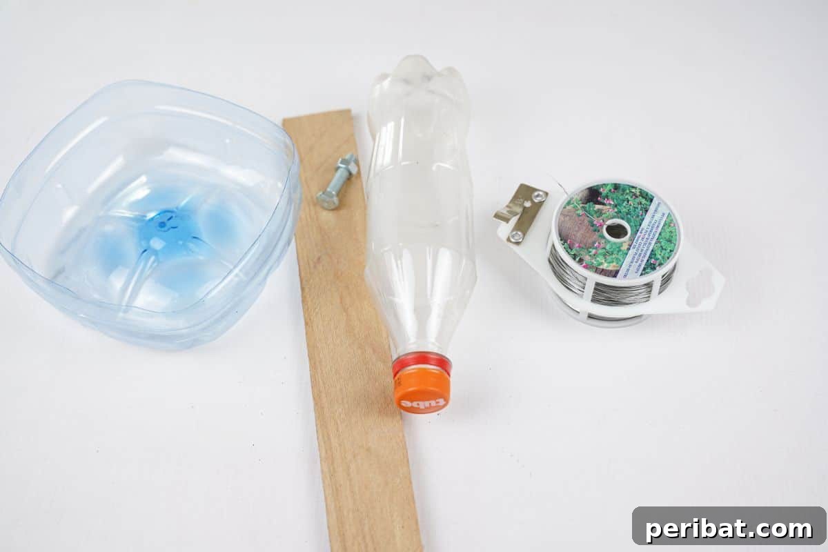 Recycled Bottle Bird Retreat 7 various crafting supplies including plastic bottles, a wood slice, and screws laid out on a white table