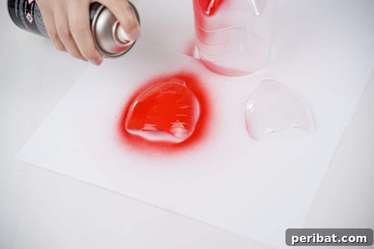 Charming Ladybug Garden Decor from Upcycled Bottles 23 plastic wing pieces being sprayed with red paint