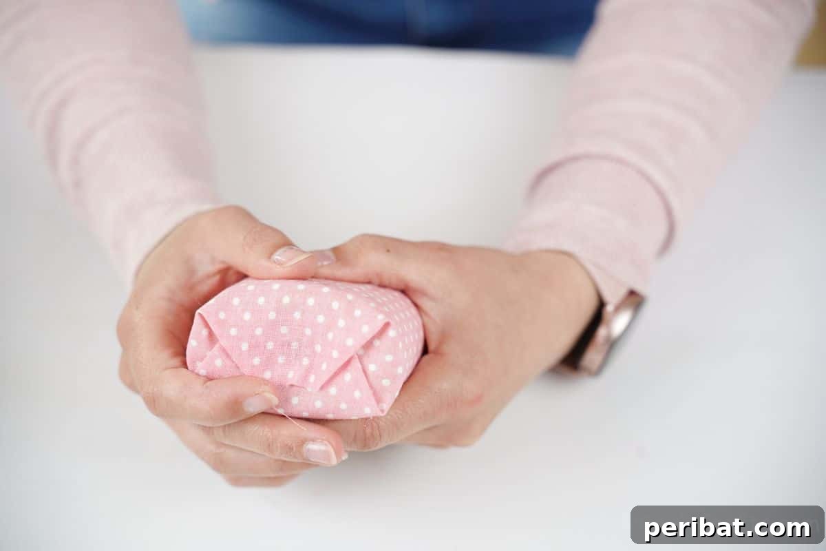fabric being folded over end of holder