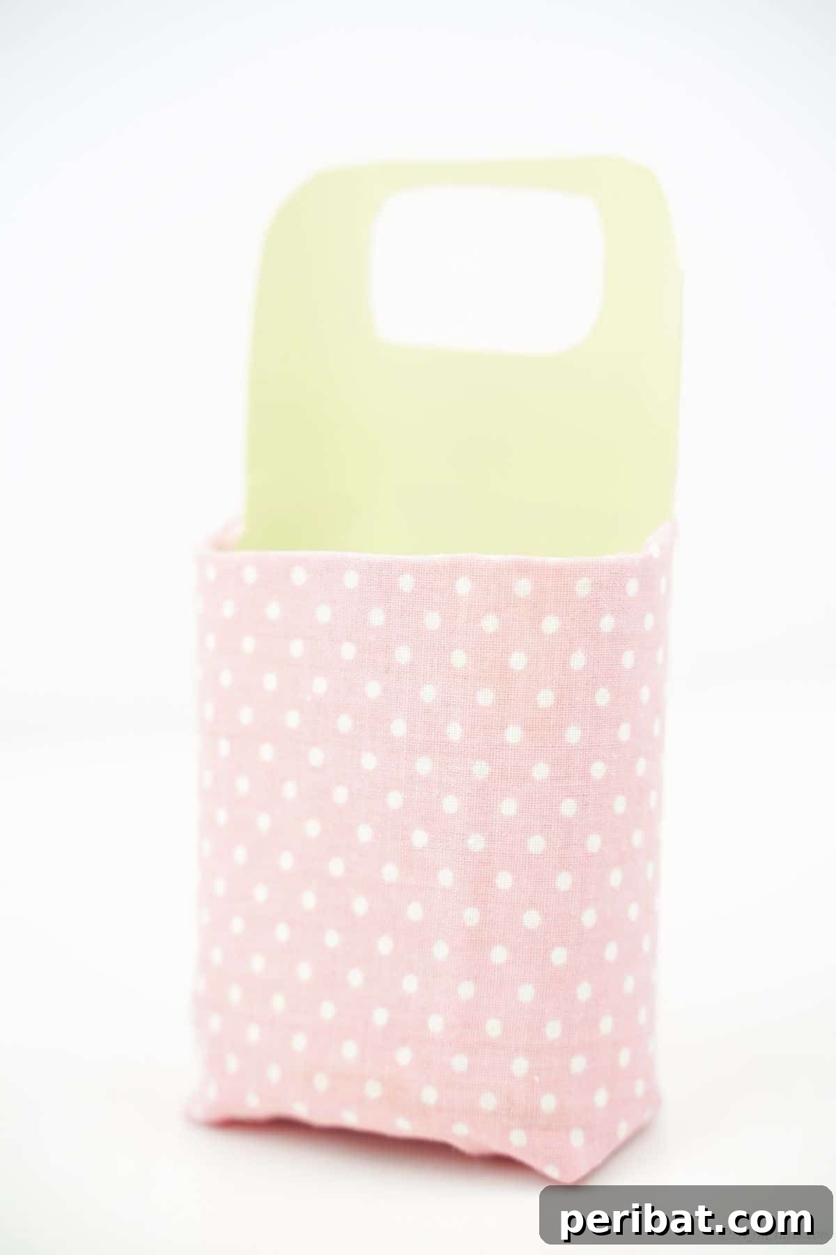 pink and green phone holder on white table