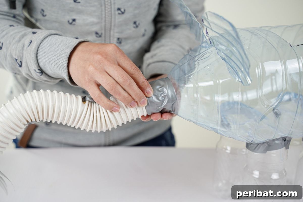 Upcycled Bottles Blossom into Adorable Elephant Planters 16 taping trunk onto plastic bottle front
