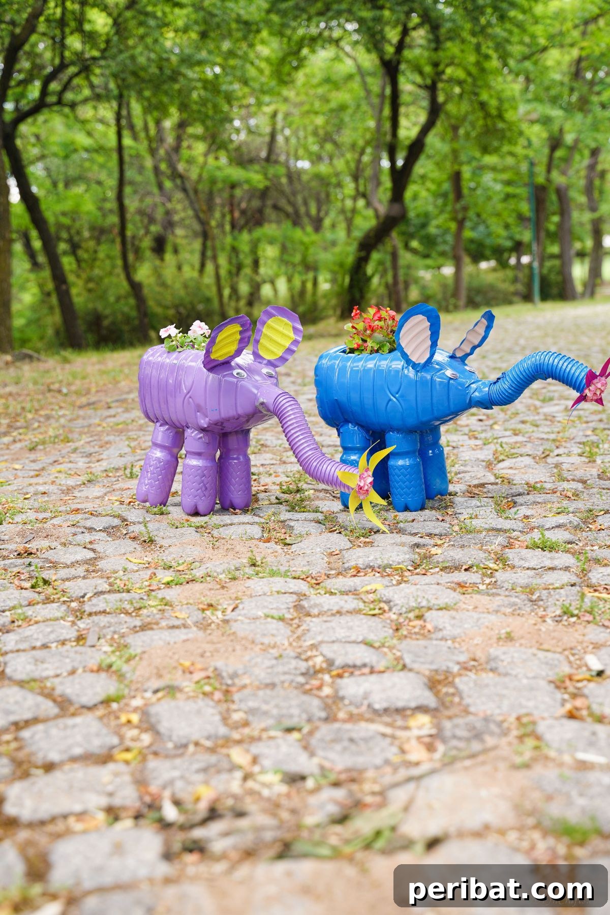 Upcycled Bottles Blossom into Adorable Elephant Planters 22 purple and blue planters with pink and red flowers on stone path