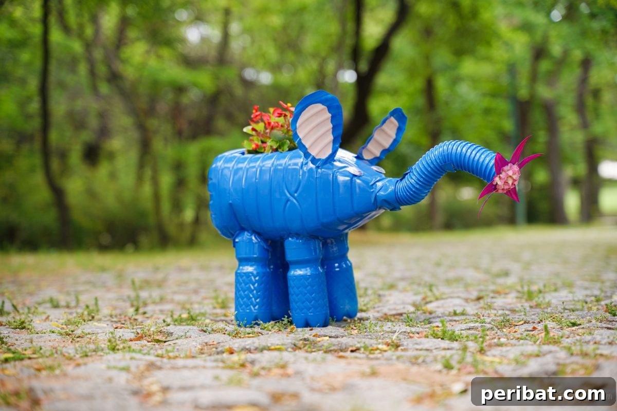 Upcycled Bottles Blossom into Adorable Elephant Planters 5 red flowers in blue elephant planter on cobblestone path