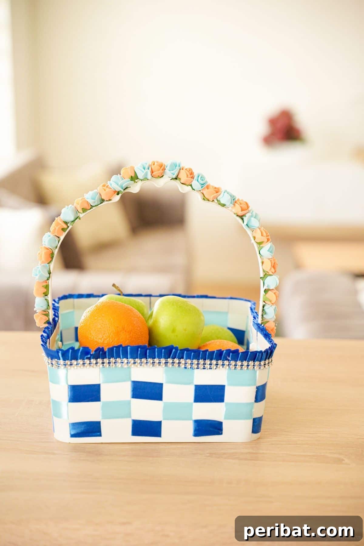 Sweet Treat Pail Transformed Basket 19 White and blue ribbon basket with fruit on a table, highlighting its aesthetic appeal and practical use.