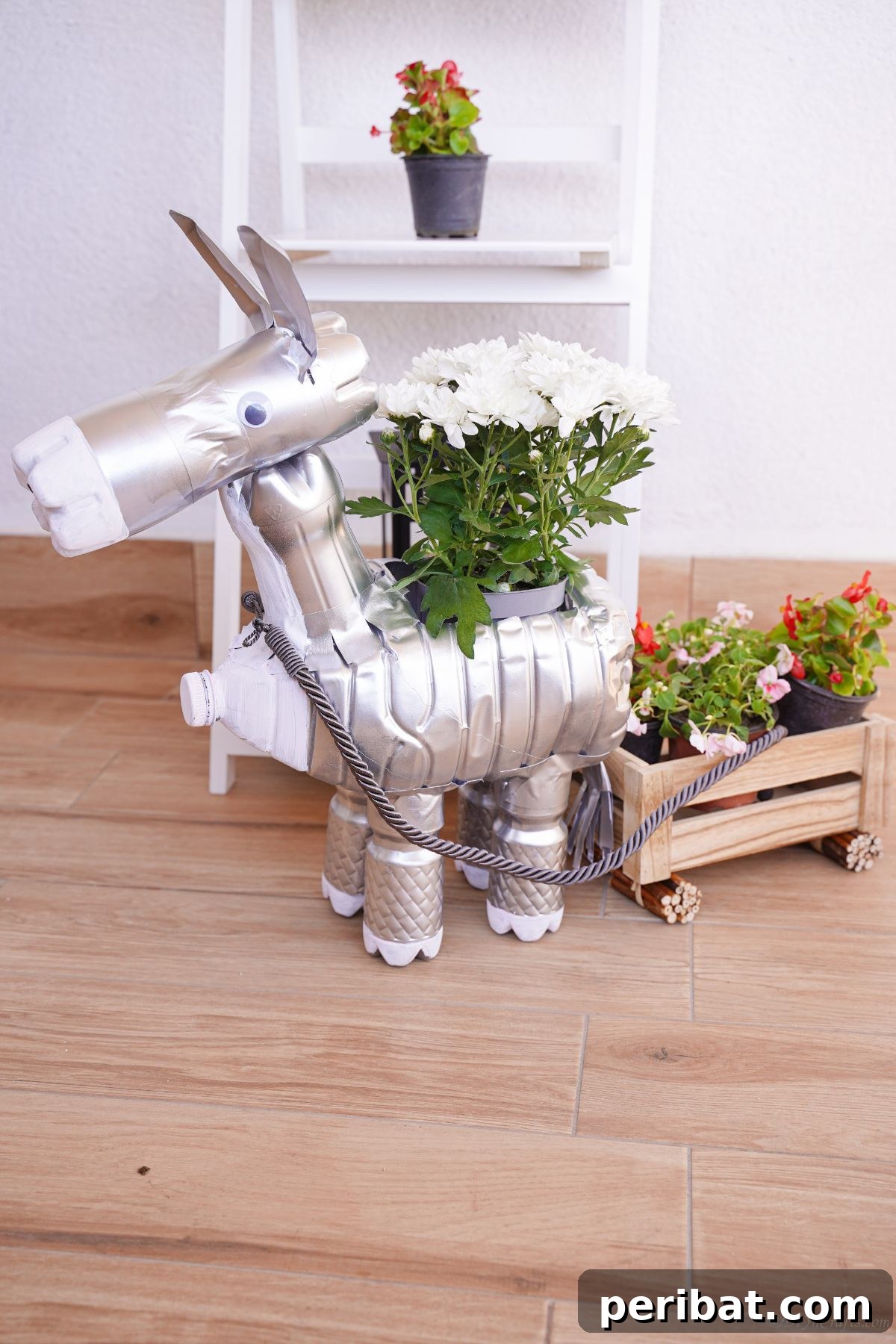 Charming Upcycled Donkey Garden Pot 22 Silver donkey planter on table in front of white shelf