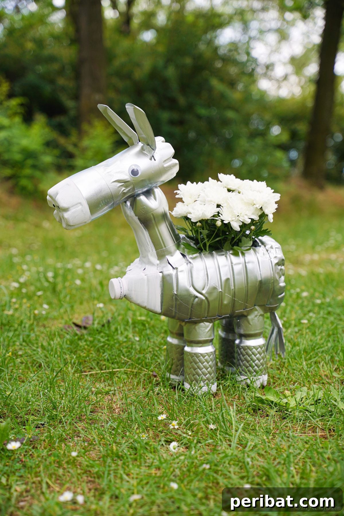 Charming Upcycled Donkey Garden Pot 23 Bottle donkey with silver spray paint outside in front of trees