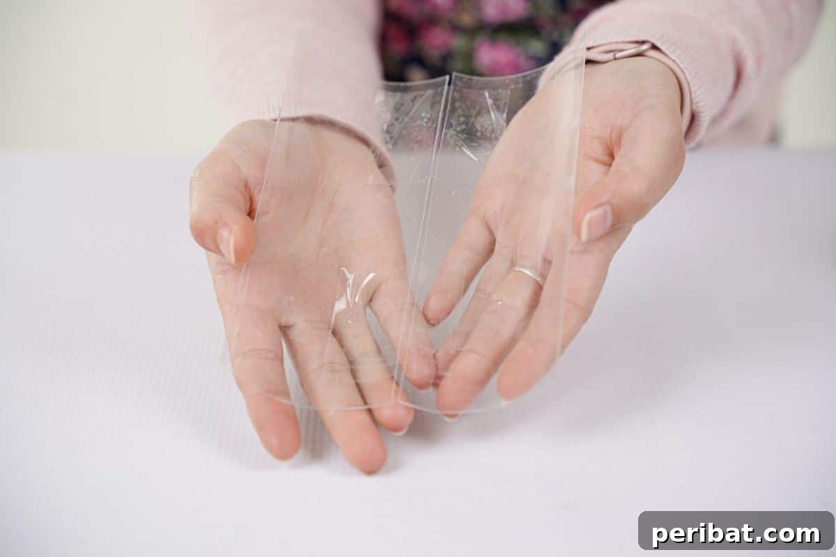 Eco-Chic Bottle Bags: Colorful DIY 15 hand holding sheets of plastic