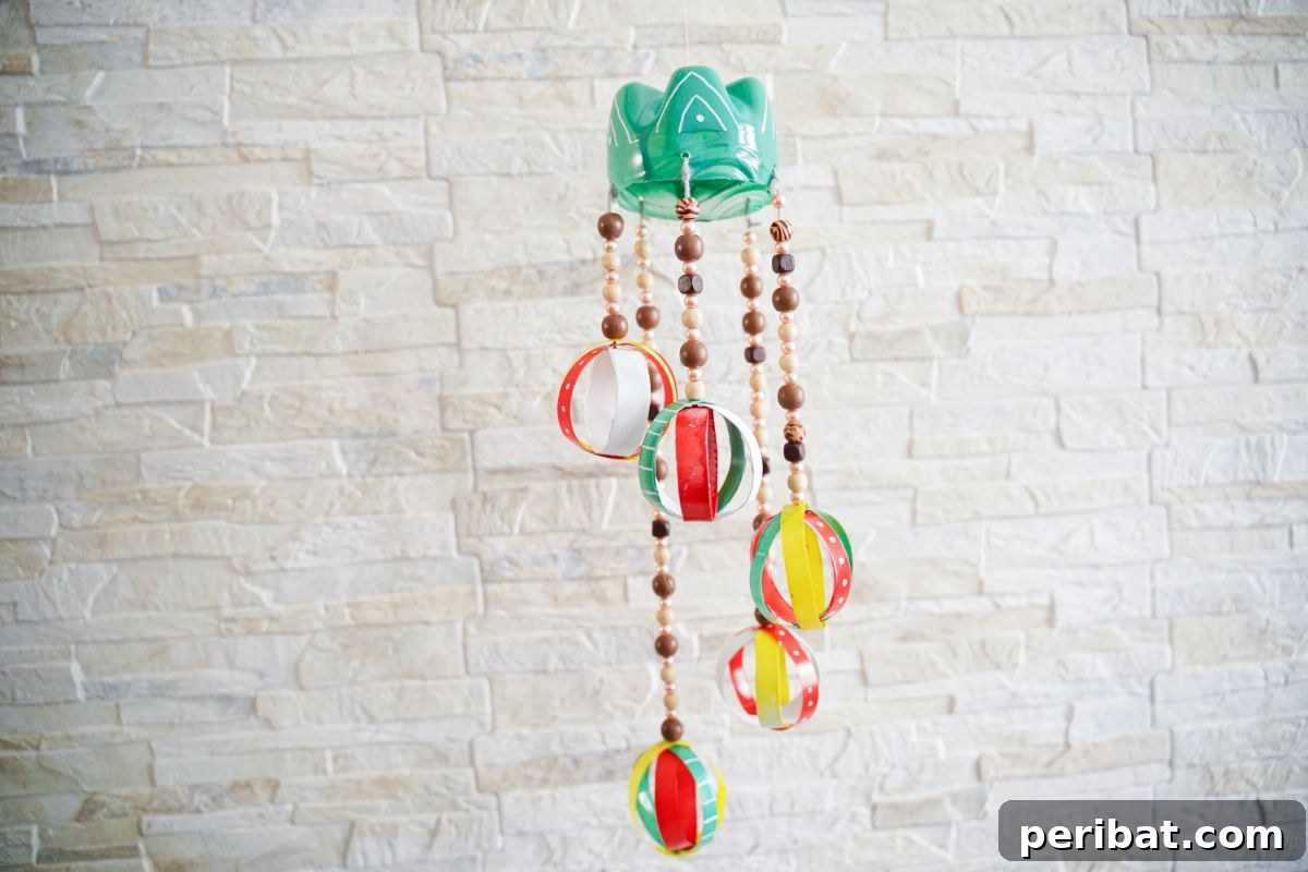 Beaded Bottle Breeze Song 3 beaded wind chime hanging by cream brick wall