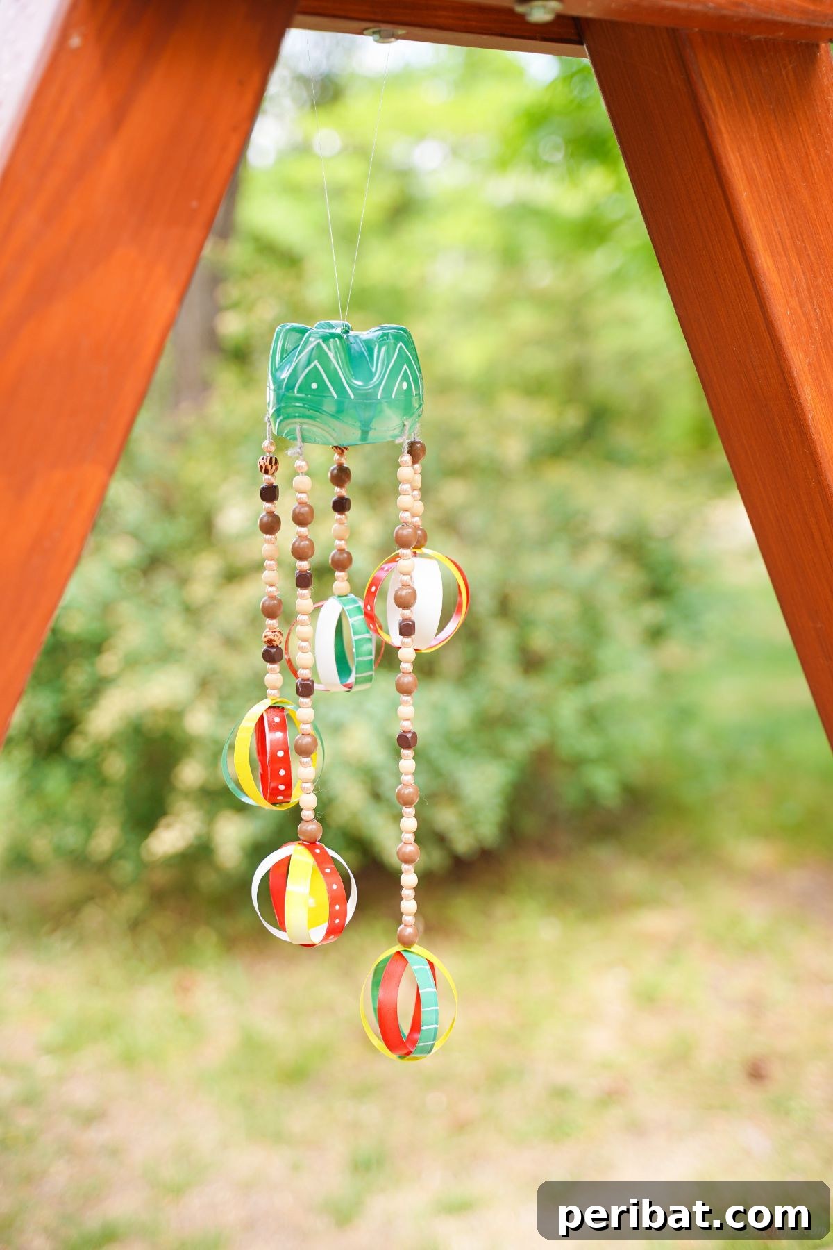 Beaded Bottle Breeze Song 4 wind chime hanging below wood frame
