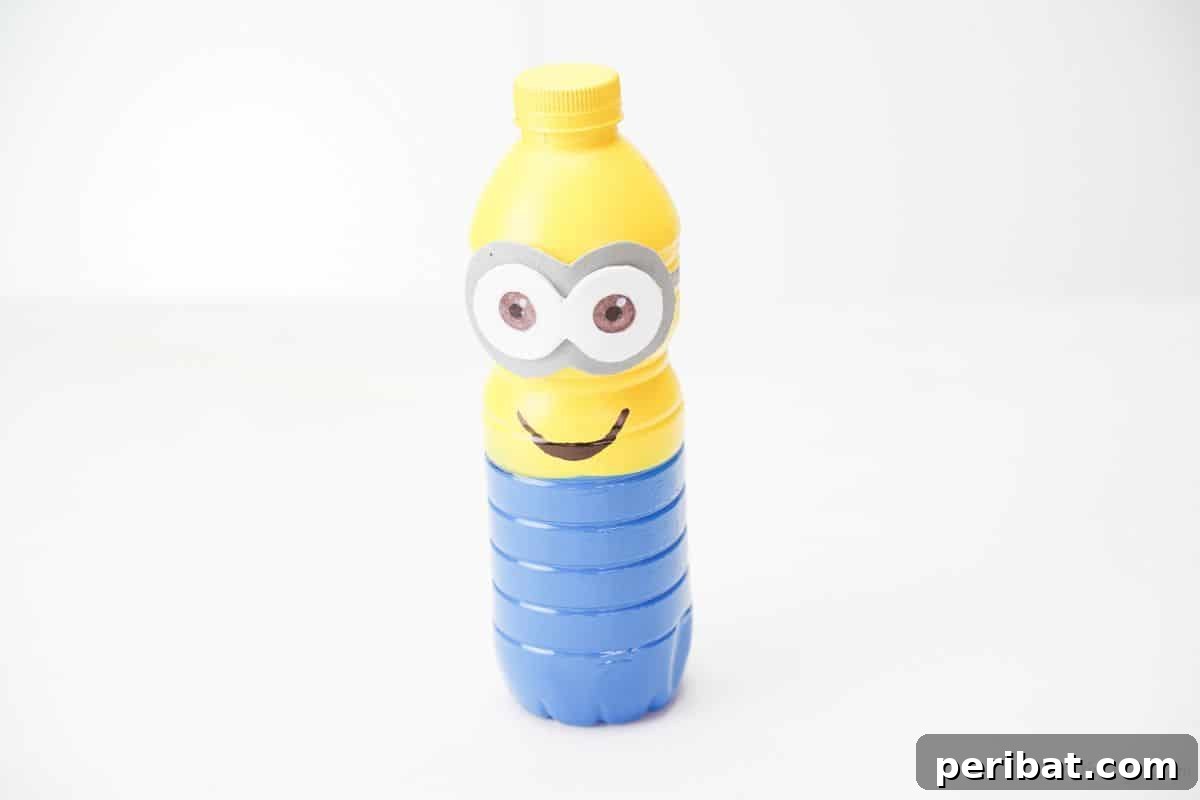 Upcycled Bottle Minion Creations 17 A finished Minion craft, lovingly made from a plastic bottle, stands proudly on a crisp white table.