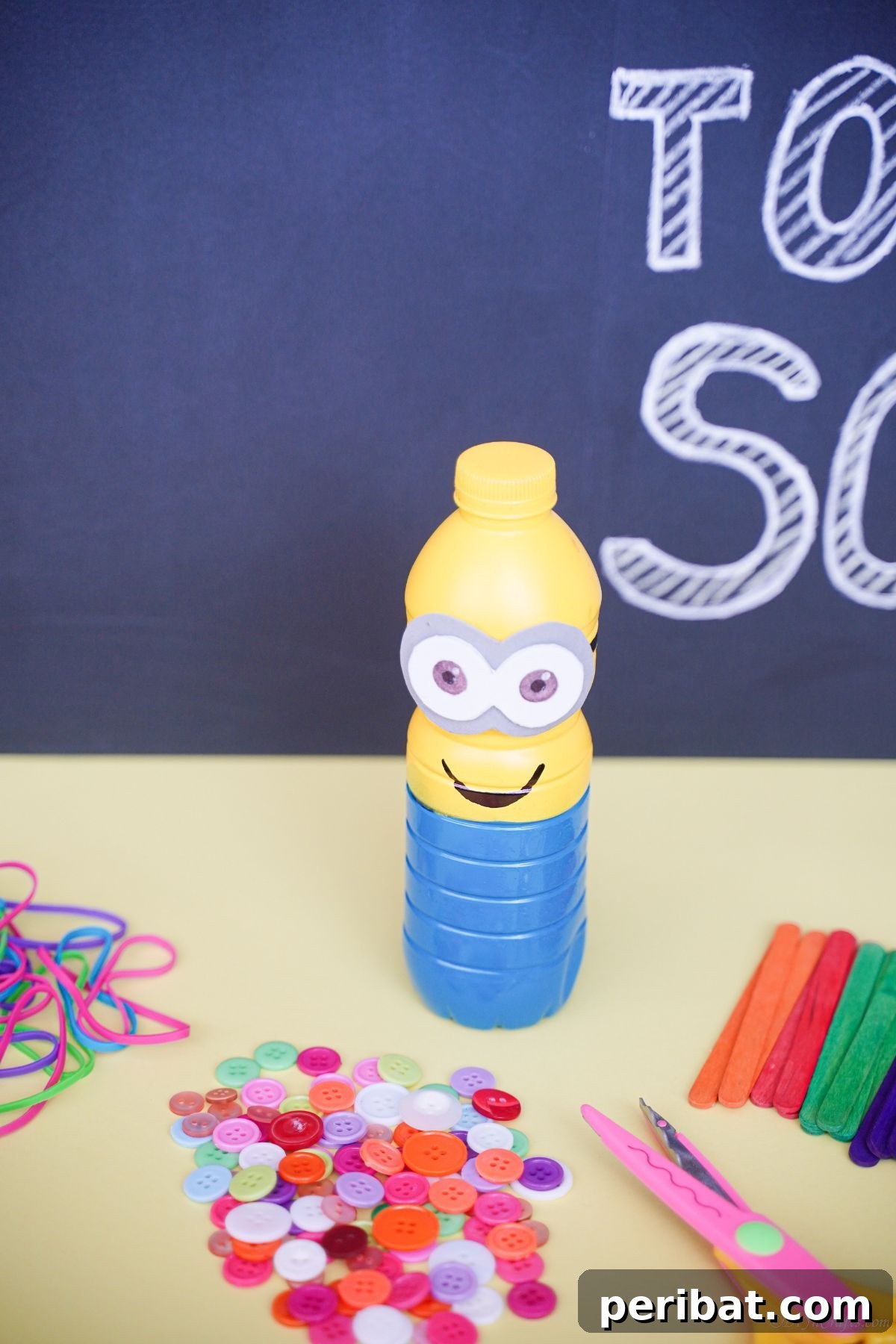 Upcycled Bottle Minion Creations 19 A charming plastic bottle Minion sits on a stylish wooden table, with a rustic chalkboard artfully blurred in the background, creating a cozy scene.