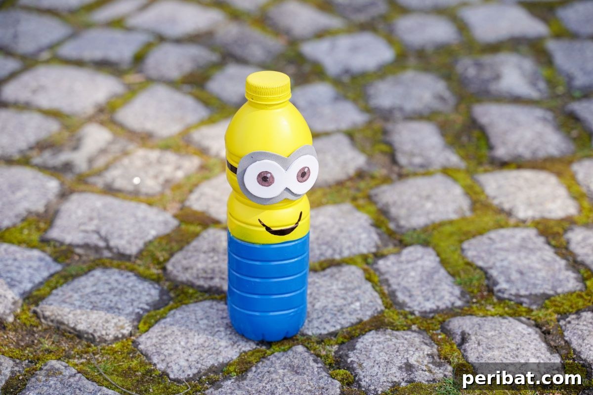 Upcycled Bottle Minion Creations 7 A charming plastic bottle Minion stands on a textured cobblestone path, offering a unique perspective from above.