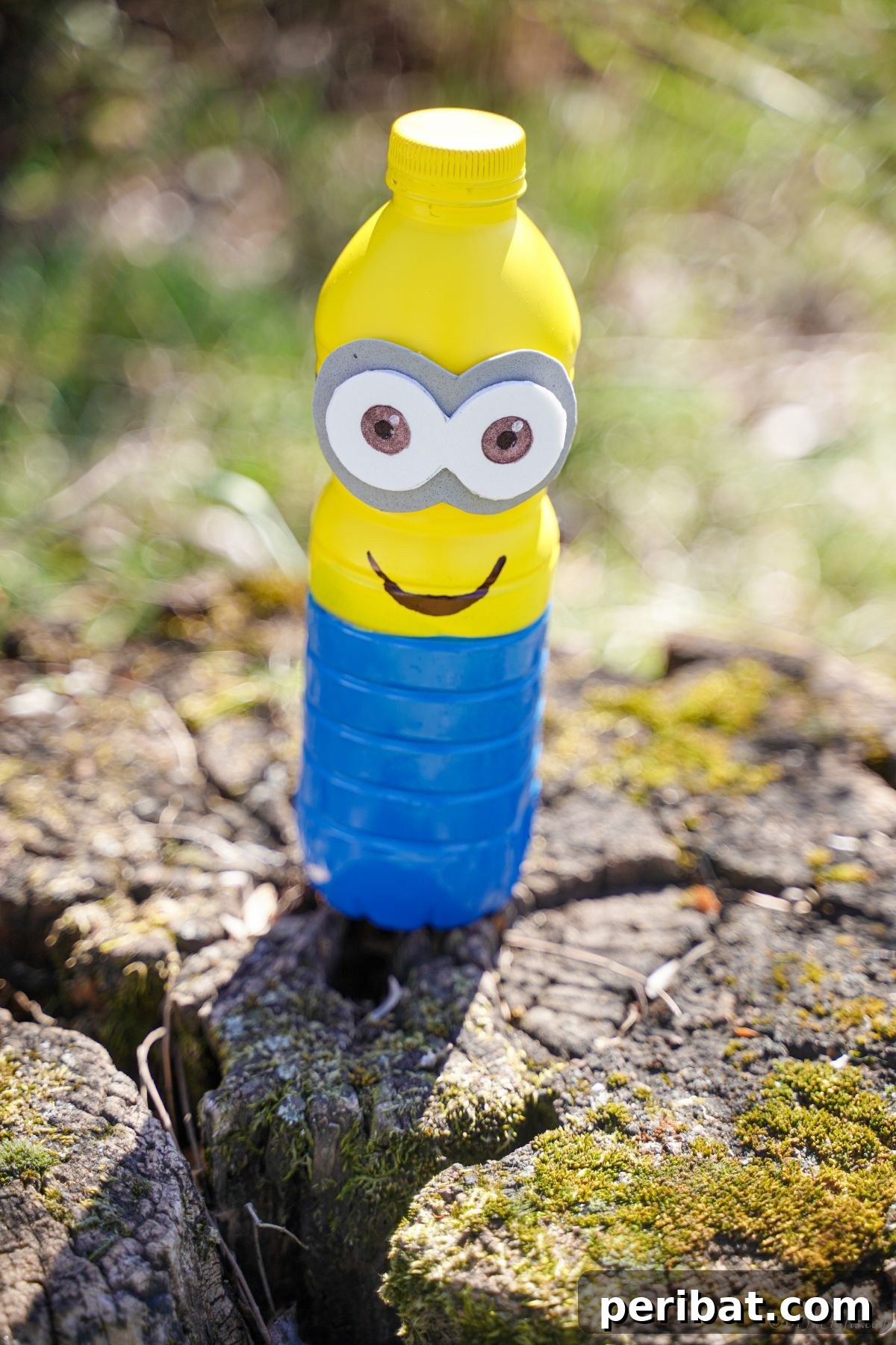 Upcycled Bottle Minion Creations 8 A handcrafted plastic bottle Minion rests on a weathered tree stump, blending its bright colors with the rustic backdrop.
