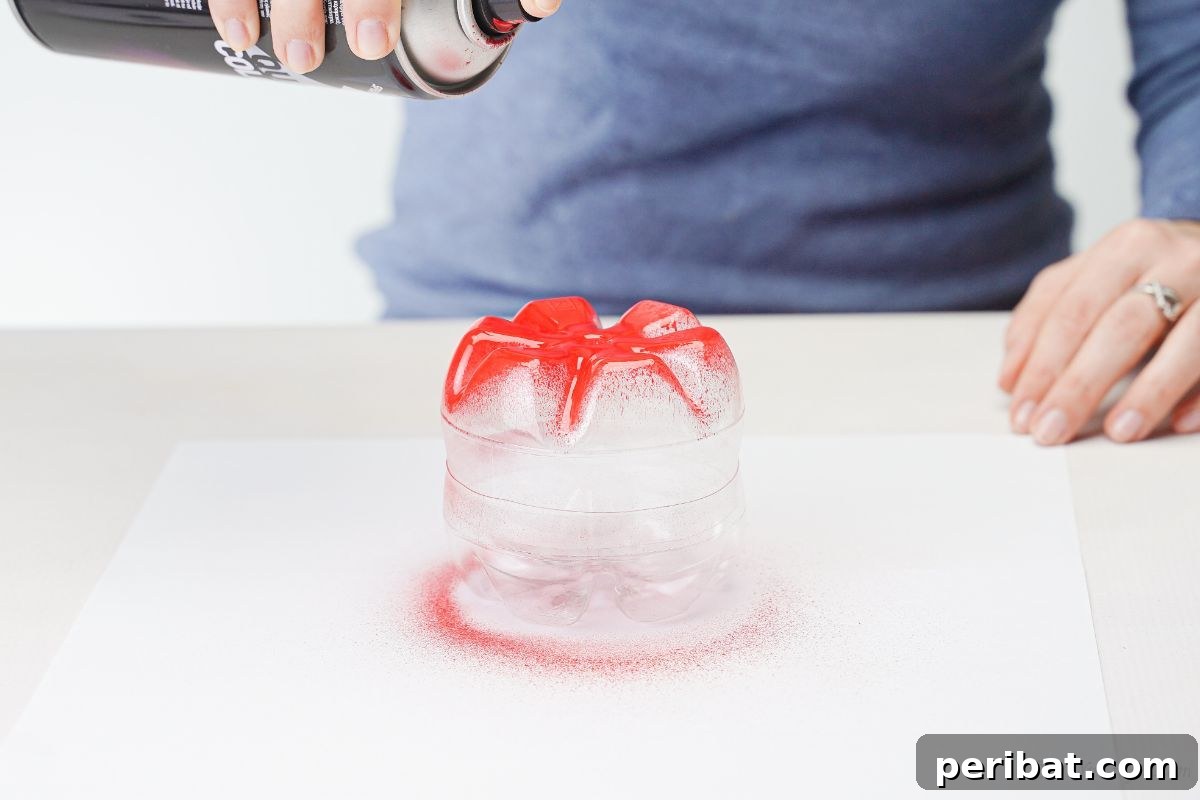 Charming Apple Plastic Bottle Teacher Gift 9 hand holding red spray paint can above plastic bottle