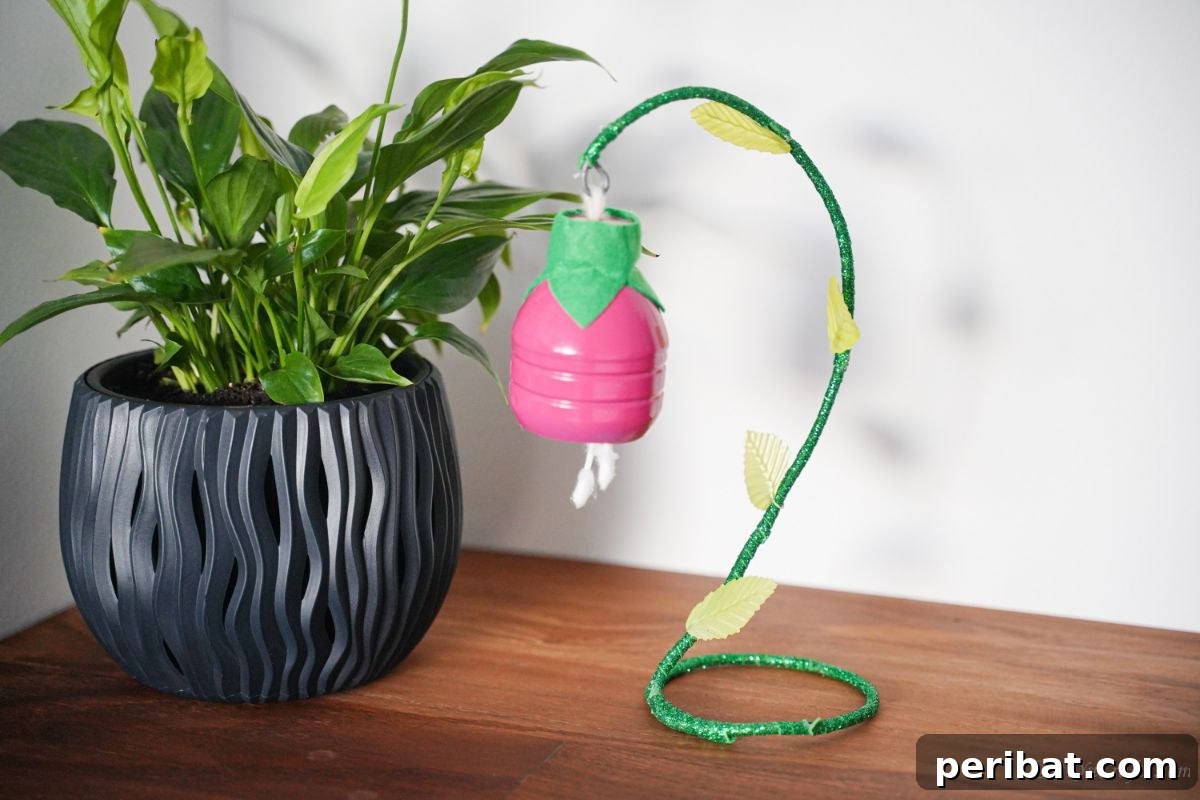 Upcycled Plastic Bottle Blossoms 14 Hand hanging a completed plastic bottle flower onto a wire hook