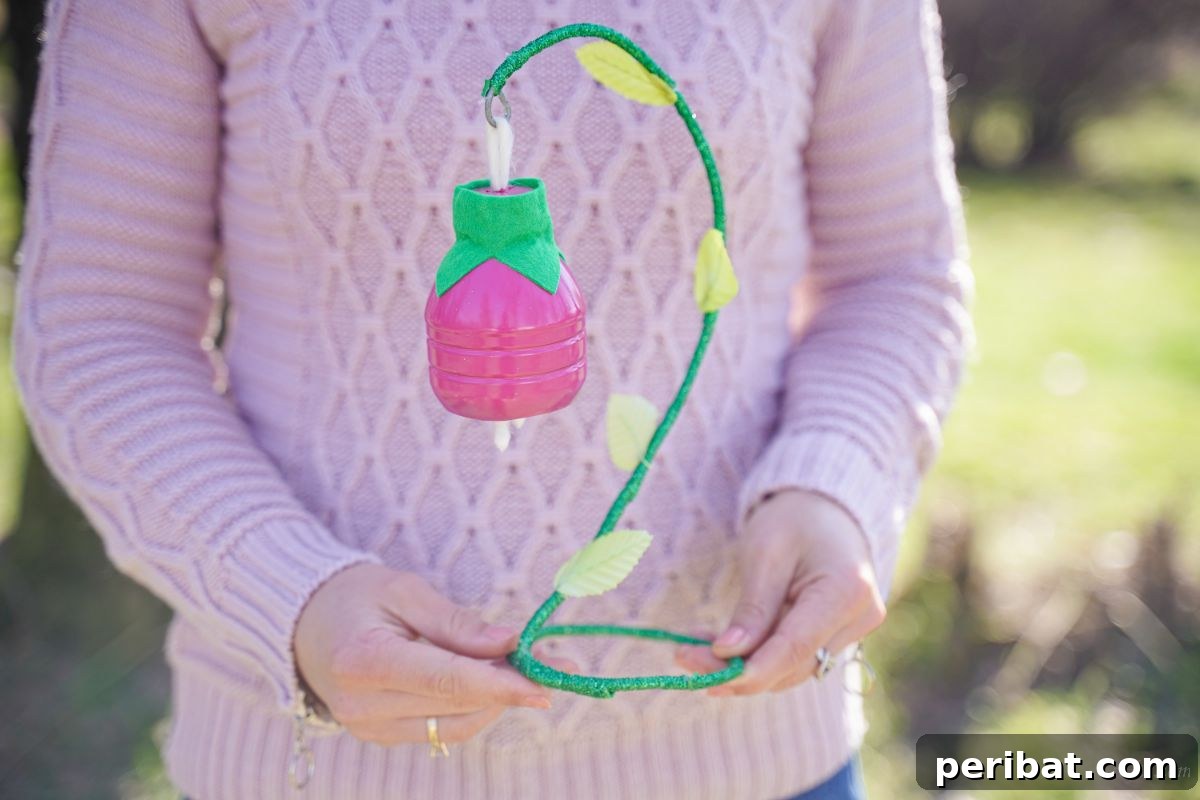 Upcycled Plastic Bottle Blossoms 3 Woman holding a beautifully crafted pink plastic bottle flower
