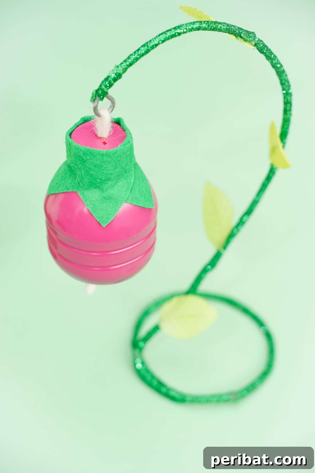 Upcycled Plastic Bottle Blossoms 5 Green background behind a beautifully crafted pink plastic bottle flower