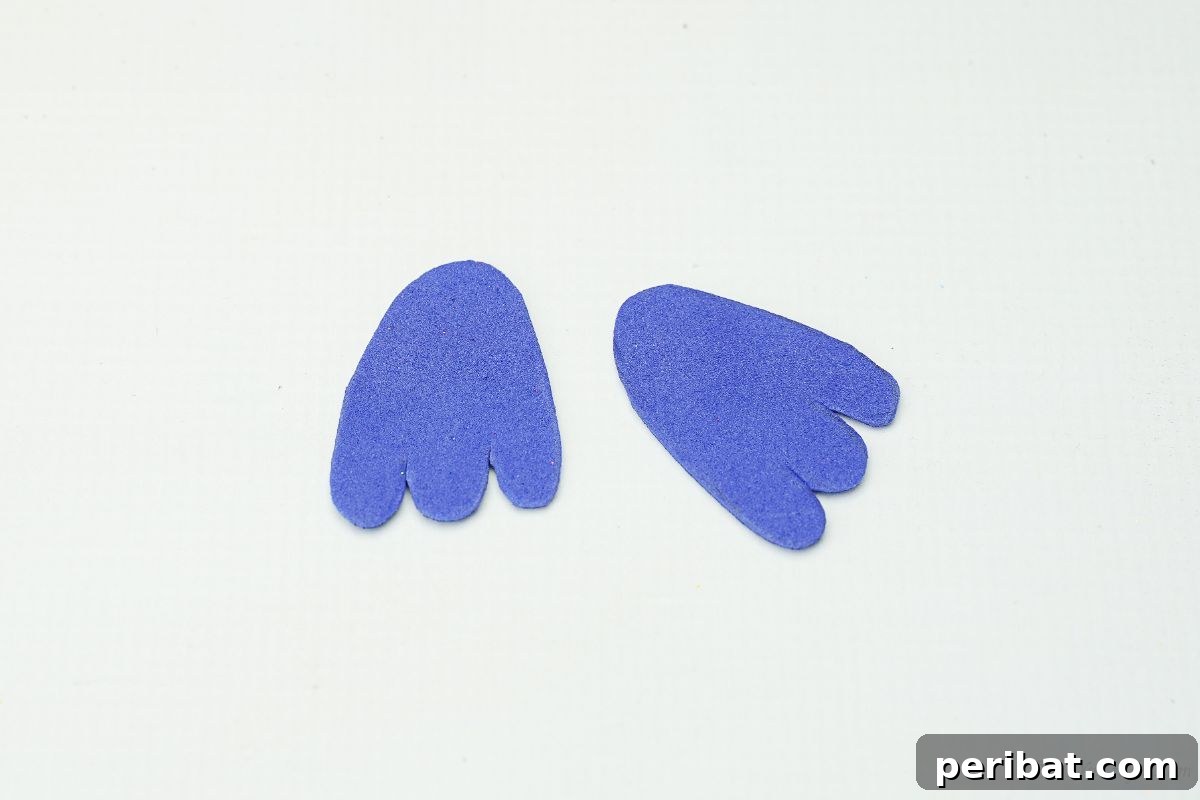 Two blue foam wings laid out on a white table, ready for assembly.