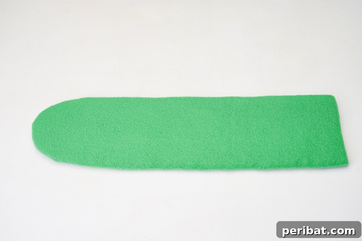 Green felt-covered curved piece of cardboard