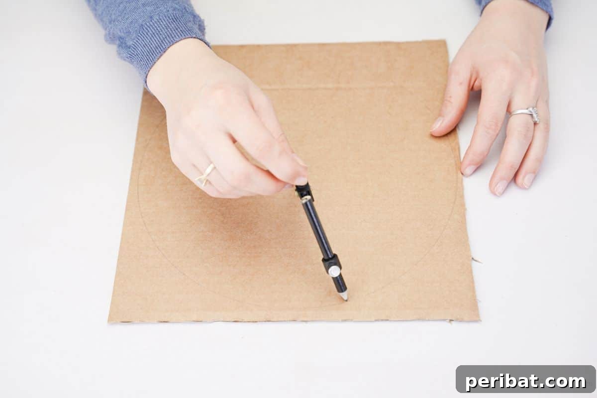 Hand holding a pencil, drawing a 10-inch circle onto cardboard for the craft base.