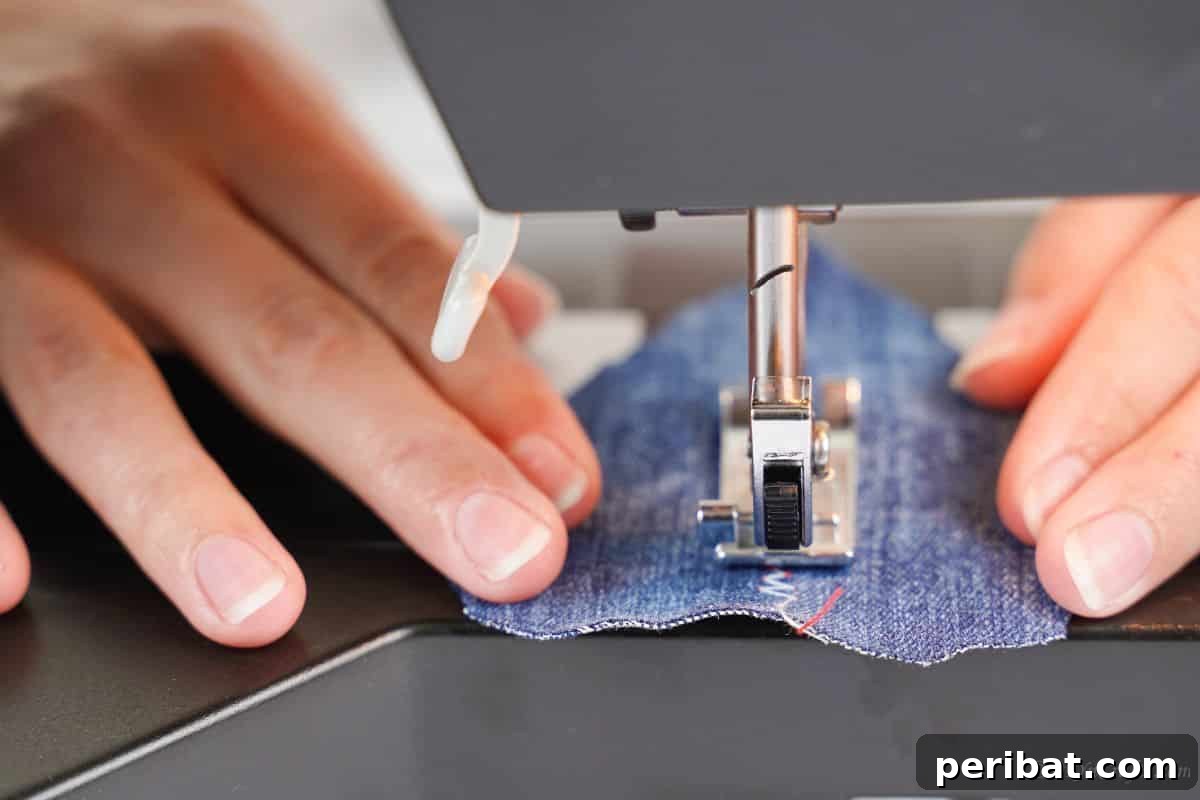 Handmade Denim Feather Keychain 4 sewing a seam in the middle of a piece of denim using the sewing machine