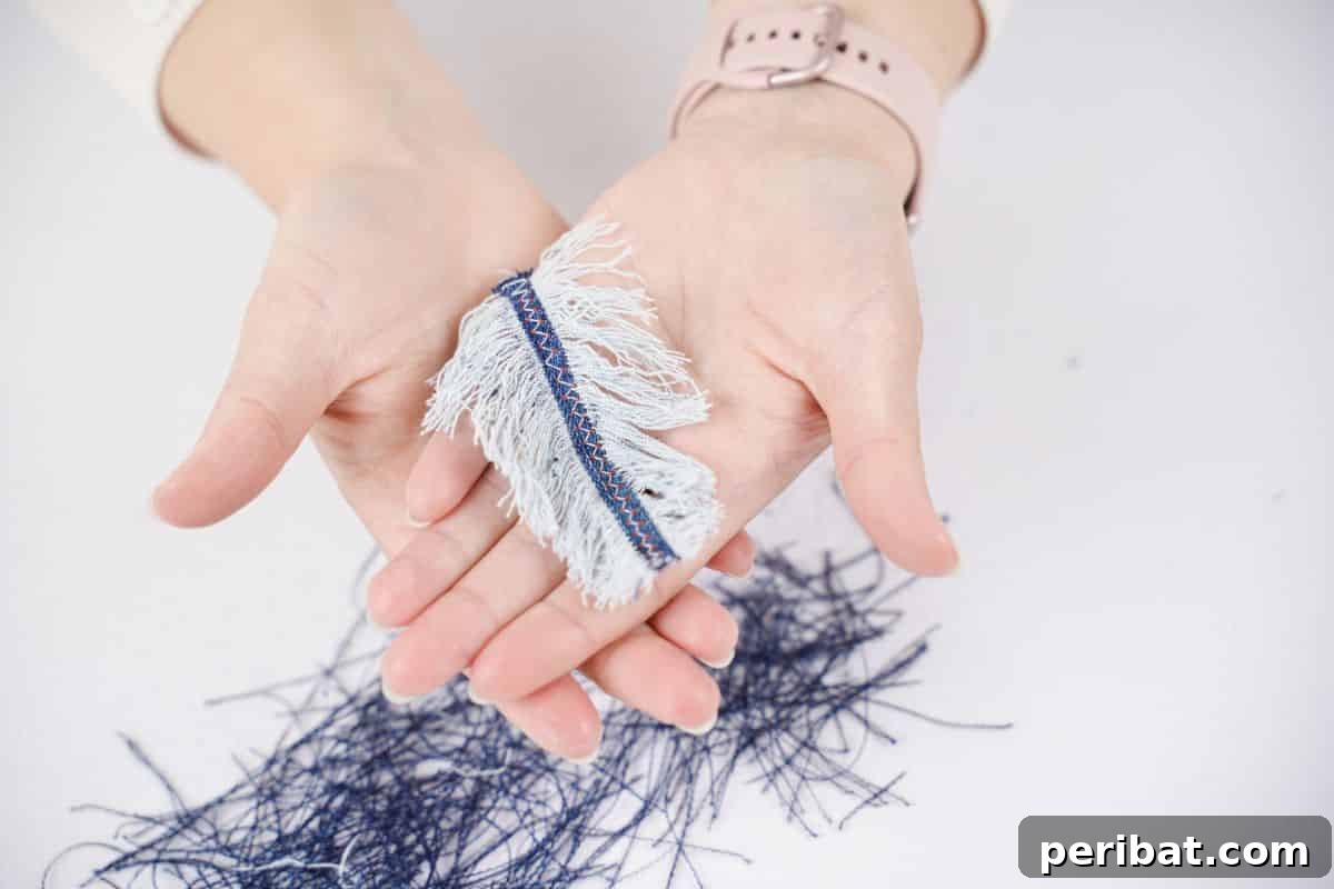 Handmade Denim Feather Keychain 5 fluffing the sides of the feather out